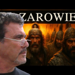 Side-profile of a man with glasses in the foreground, looking left, with a fiery battle scene and armored warriors behind; 'ZAROWIE' banner above.